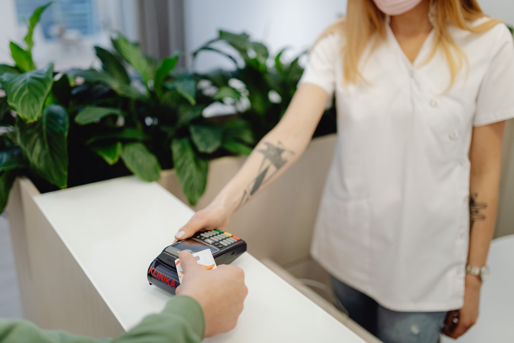 Person paying with a card at a payment terminal
