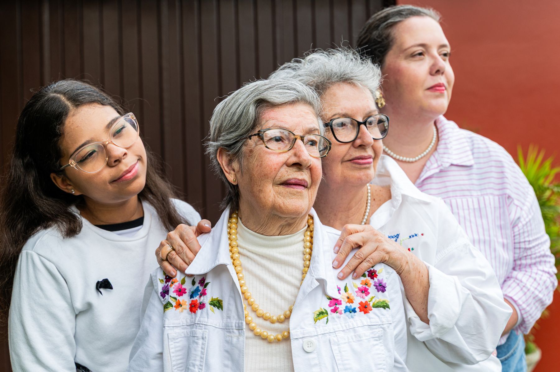 Three generations of women standing together outdoors