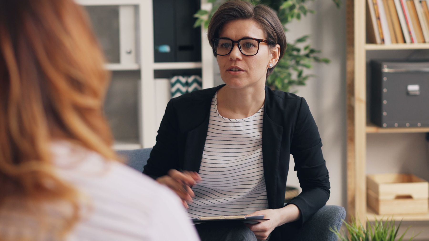 Therapist listening to a client in a calm office
