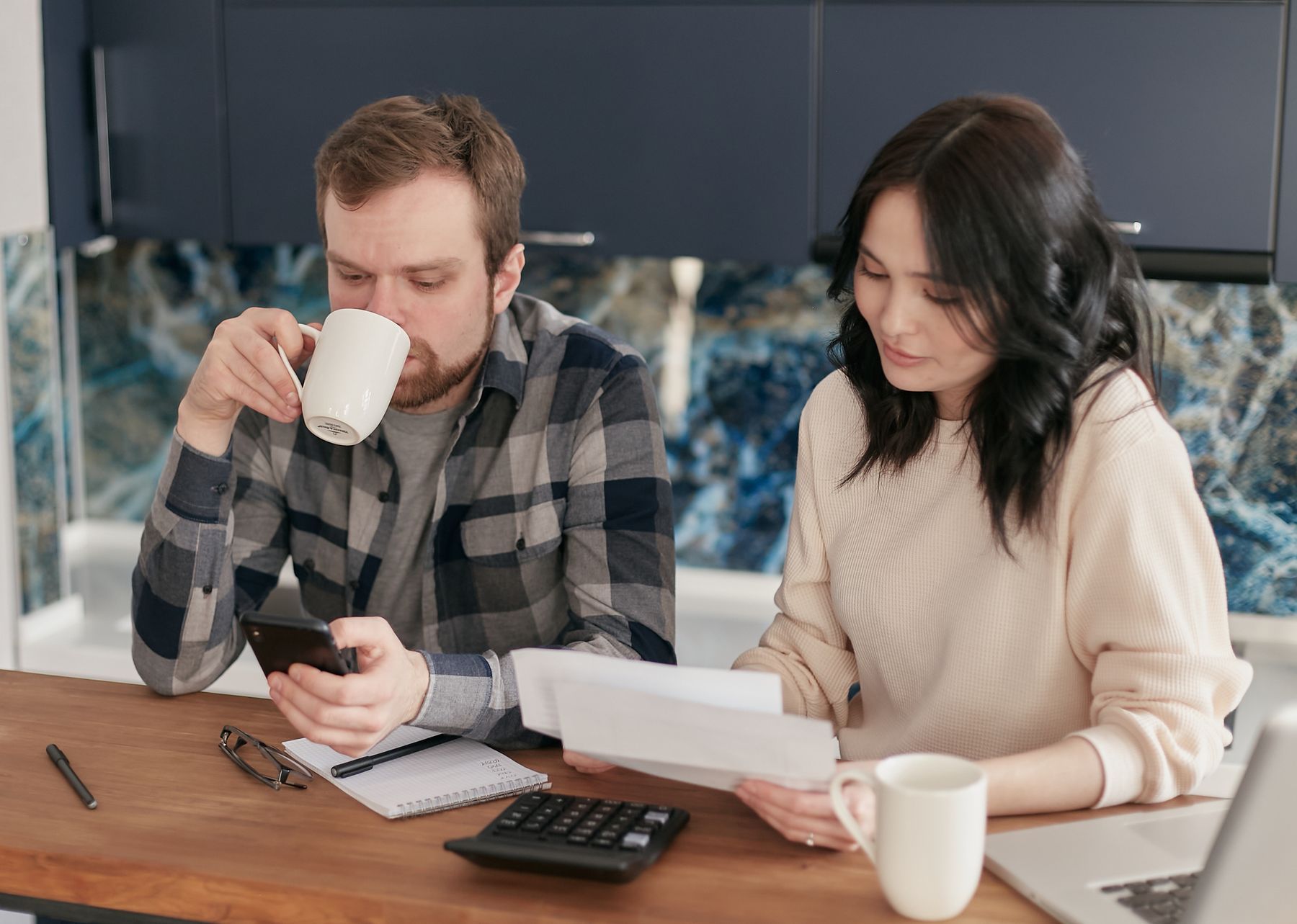 Couple at a table reviewing bills and expenses together